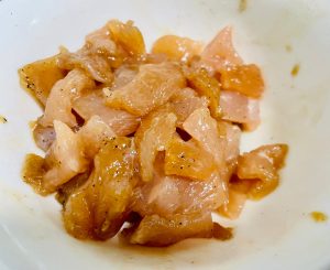 Next, cut the chicken breast into bite-sized cubes. Place them in a bowl with all the marinade ingredients. Mix vigorously until the liquid is fully absorbed. Let it rest for 10 minutes.