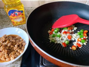Aromatics: Add the minced garlic and sliced chilies to the remaining oil. Stir-fry until highly fragrant, about 15 seconds.