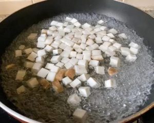 Blanch the Mushrooms: Bring a pot of water to a boil. Add the diced mushrooms and blanch for 2 minutes. Afterward, rinse them under cold water and gently squeeze out the excess moisture. This is crucial to prevent a watery stir-fry.