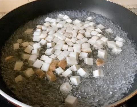 Blanch the Mushrooms: Bring a pot of water to a boil. Add the diced mushrooms and blanch for 2 minutes. Afterward, rinse them under cold water and gently squeeze out the excess moisture. This is crucial to prevent a watery stir-fry.