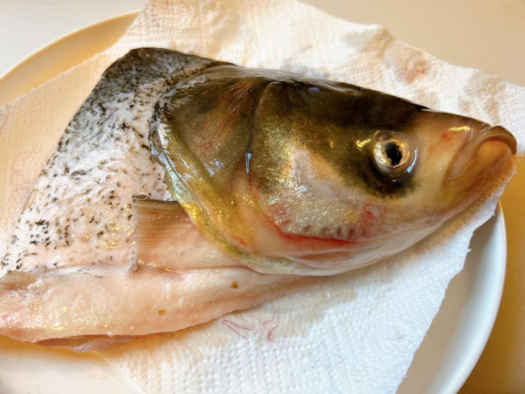 Rinse the fish head thoroughly under cold water, removing any remaining gills or bloodlines.