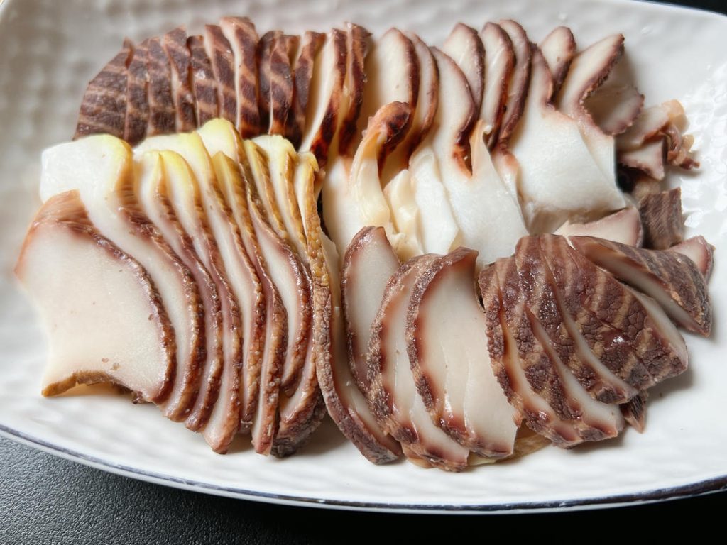Slice: Halve the cleaned meat down the middle. Then, using a sharp knife, slice it very thinly against the grain.