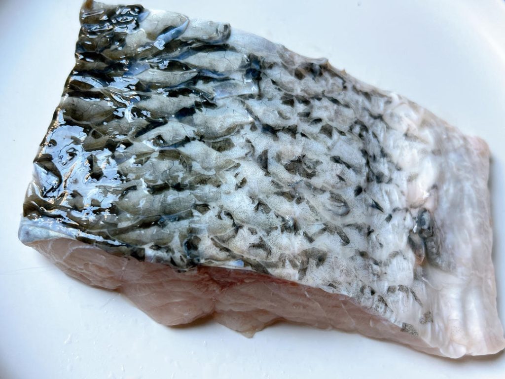 First, thoroughly clean your fish. If you are using whole cuts, you must remove the black membrane from the belly cavity. This membrane contains compounds that taste incredibly muddy and fishy.