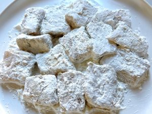 Coat the Fish: Remove the ginger and scallions from the marinated fish. Toss the chunks in the remaining 1/2 cup of cornstarch until evenly dusted. Shake off any excess.