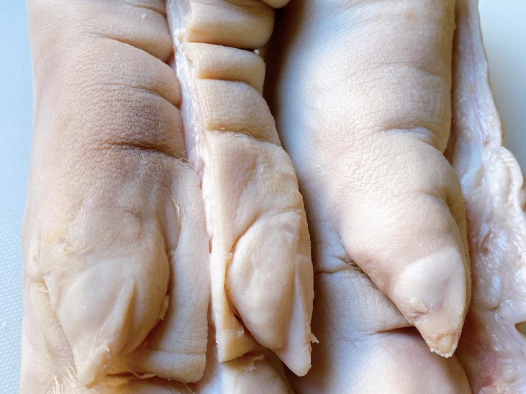 Have your butcher split the trotters in half down the middle. Front trotters are highly recommended over hind trotters because they contain more meat and tendons, whereas hind trotters are mostly bone. A quick way to tell the difference: front trotters can bend, have visible wrinkles, and feature uniform toes.