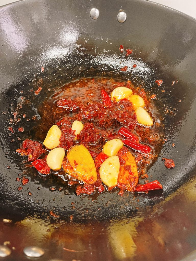 Braise the Crayfish Return the crayfish to the wok. Toss to coat in the aromatic oil. Add the Shaoxing wine, Light Soy Sauce, and sugar. Pour in the beer.