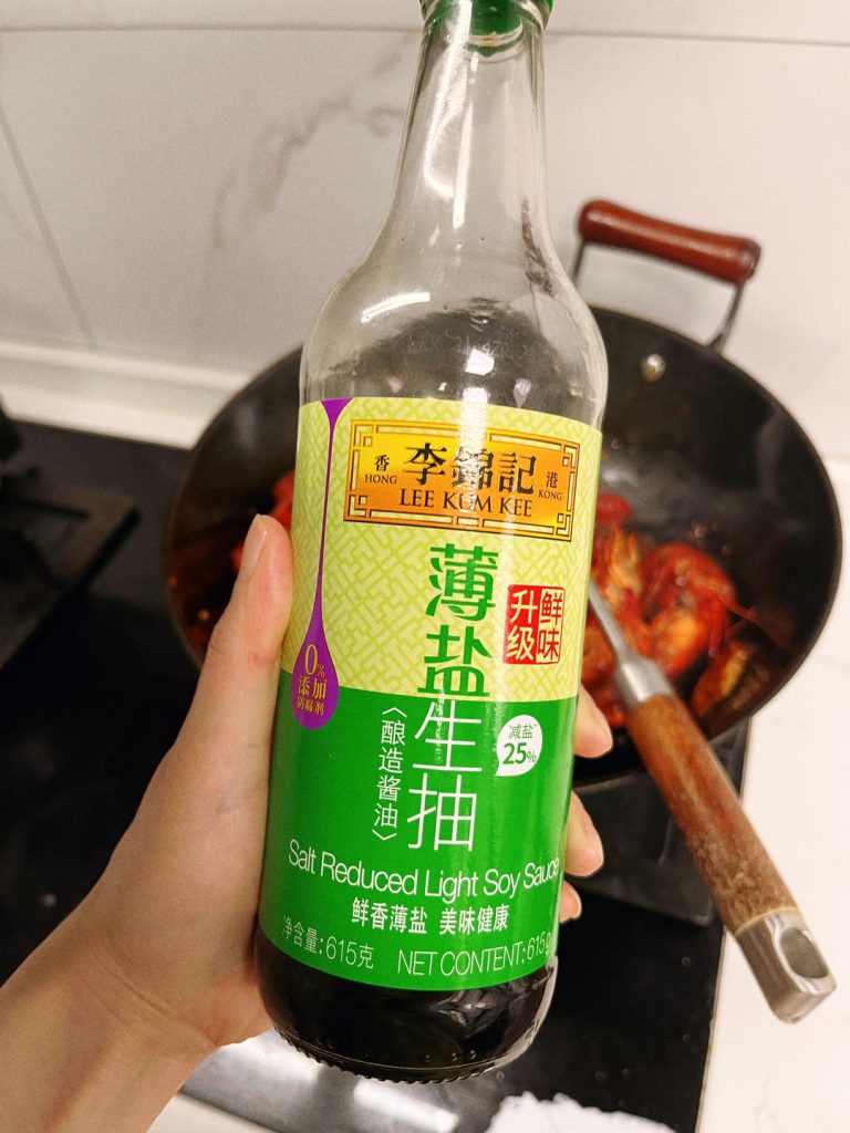 Braise the Crayfish Return the crayfish to the wok. Toss to coat in the aromatic oil. Add the Shaoxing wine, Light Soy Sauce, and sugar. Pour in the beer.