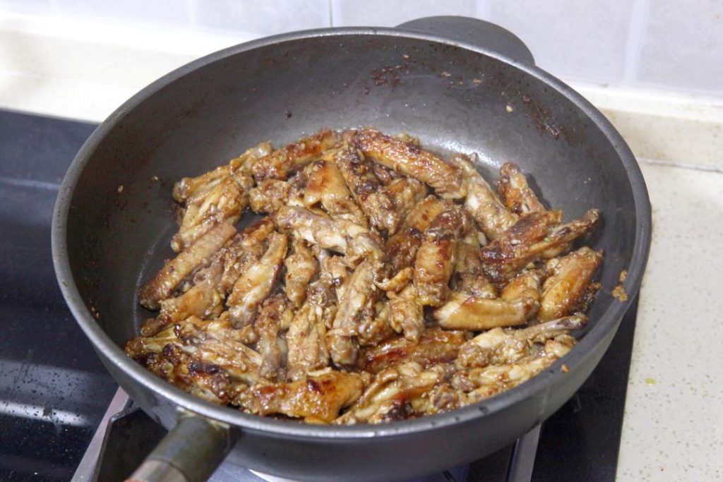 Add Aromatics Once the garlic is fragrant and the sauce coats the wings, add the green and red pepper rings. Stir-fry for about 30 seconds until the peppers are slightly tender but still crisp ("Duan Sheng").