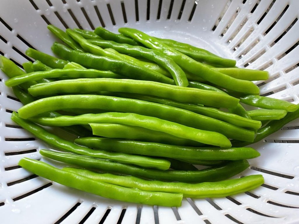 Cool the Beans: Use a slotted spoon to remove the beans. Immediately rinse them under cold running water for 30 seconds. This stops the cooking process. Drain them well.