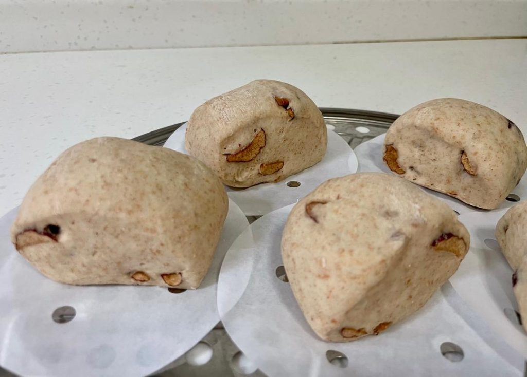 Second Proof: Place the buns in the steamer basket. Cover and let them rest (proof) for exactly 10 minutes.