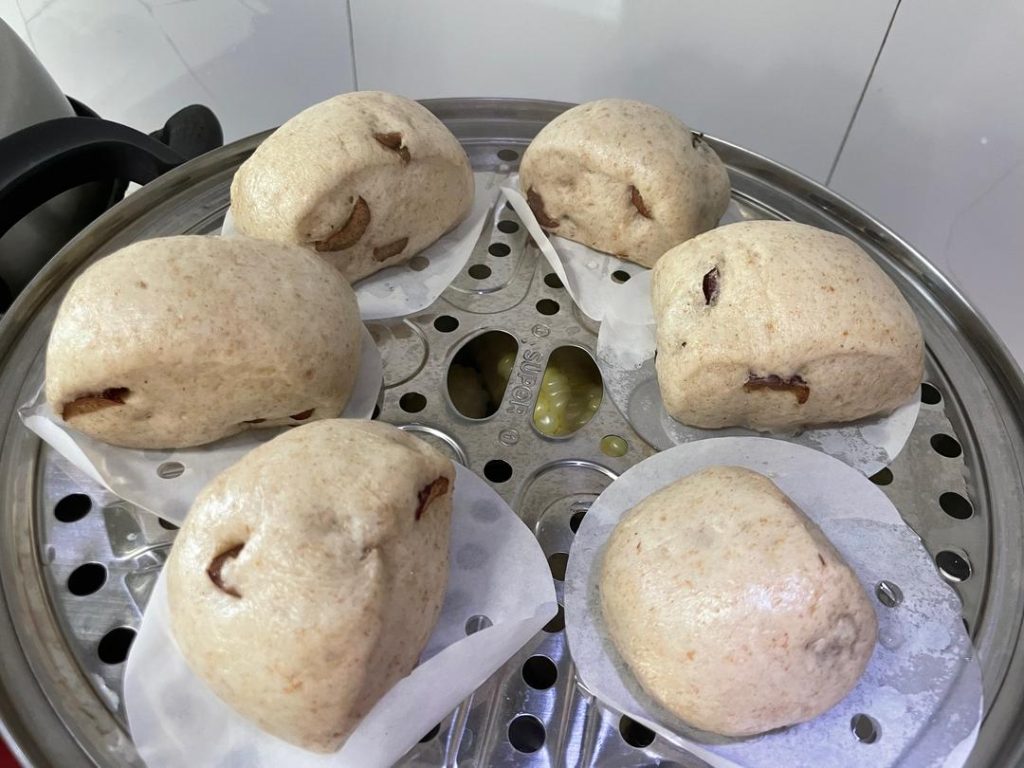 Second Proof: Place the buns in the steamer basket. Cover and let them rest (proof) for exactly 10 minutes.