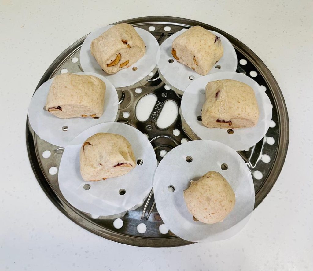 Cut: Use a sharp knife to cut the cylinder into 6 equal pieces. Place each piece onto a square of parchment paper.