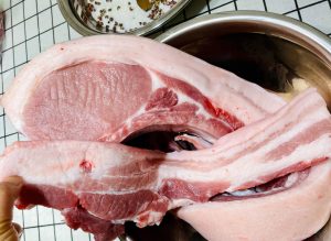 Cut your 5.5 lbs of pork belly into long strips (about 1.5 to 2 inches wide) to ensure even curing and drying. Do not remove the skin.