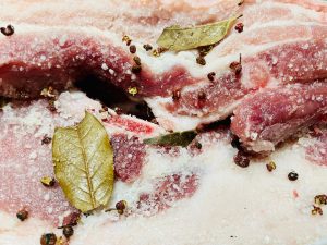 Once the salt mixture is cool, rub it thoroughly over every inch of the pork belly strips. Ensure you get into the crevices and coat the skin. Place the pork in a large bowl or container. Let it cure in a cool place (refrigerator is safest) for 3 to 4 days. Turn the meat once a day to redistribute the juices that will be drawn out.