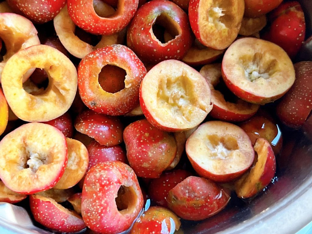 Next, remove the stems and seeds. You can slice around the equator of the berry and pop the seeds out. However, my favorite restaurant kitchen hack is using a sturdy boba (bubble tea) straw! Simply push the straw through the center from the stem end to cleanly core the fruit.