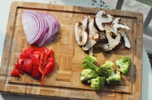 Chop Veggies: Slice the onion, red pepper, and shiitake mushrooms. Cut the broccoli into small florets.