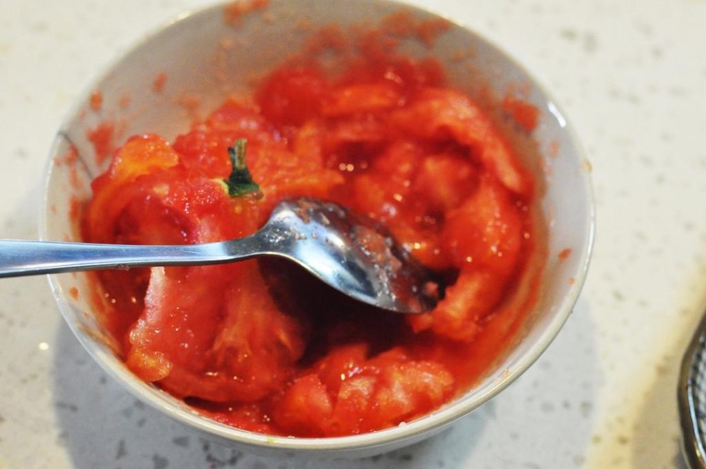 Make the Fresh Tomato Base In a pot, boil enough water to submerge the tomato. Score a small "X" on the bottom of the tomato. Boil over medium heat until the skin splits (about 2-3 minutes). Remove, peel the skin, and mash the flesh into a puree. Mix in the white sugar and salt. Set aside.