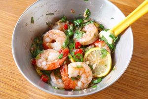 Add the lemon slices and chopped cilantro to the sauce. Add the cooked, drained shrimp.
