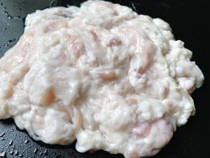 Once inverted, you will see clumps of white fat and dark, reddish, granular lymph nodes. Use your fingers or scissors to pull off and discard the lymph nodes. They must be removed. You can leave a little white fat for flavor, or strip it entirely for a leaner dish.
