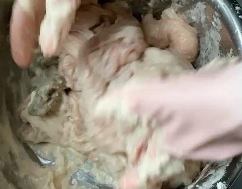 Place the unwashed intestines in your large basin. Add 2 tablespoons of flour. Begin kneading and rubbing the flour into the surface. The flour will clump as it absorbs the thick mucus. If it feels too dry, add a tiny splash of water.