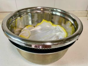 The Drainage Setup: Place the colander inside a larger pot or bowl (an old rice cooker pot works great) to catch dripping water. Crucial: Ensure the bottom of the colander is not touching the drained water.