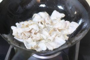 Render the Pork Heat your wok or large skillet over medium-high heat. Add the sliced pork belly. Stir-fry until the meat changes color and the edges begin to turn slightly golden.