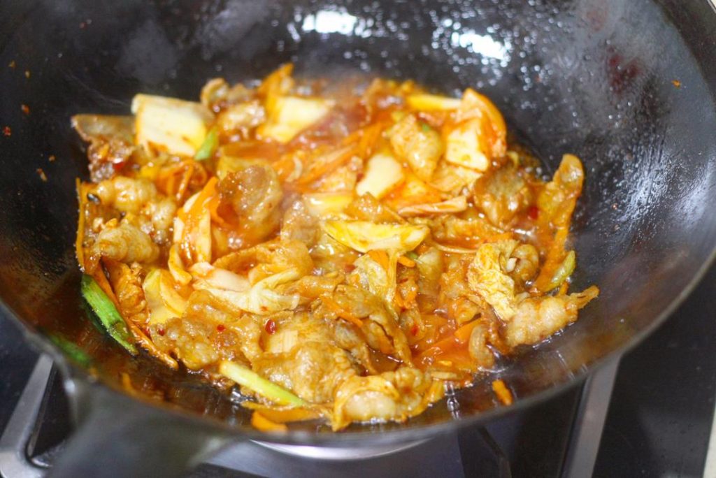 Season Pour the Shaoxing Wine and Light Soy Sauce around the perimeter of the wok (not directly on the meat). Toss everything quickly to coat.