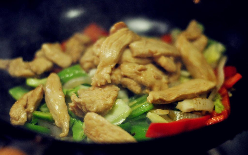Combine and Season Add the cooked chicken back into the wok. Now, add the Gochujang (Korean chili paste). Start with 2 tablespoons if you are sensitive to spice, or go for 3 if you love heat. Stir well to coat everything evenly.