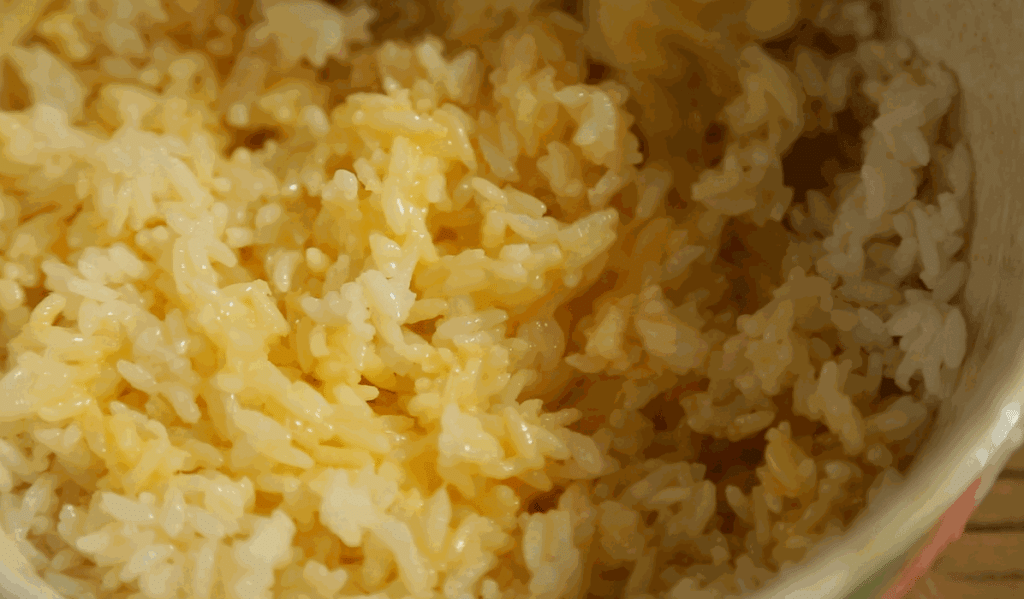Fry the "Golden" Rice: Heat your wok or skillet over medium heat. Add 1 tablespoon of oil. Add the egg-coated rice. Stir-fry constantly.
