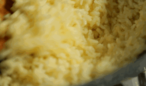 Fry the "Golden" Rice: Heat your wok or skillet over medium heat. Add 1 tablespoon of oil. Add the egg-coated rice. Stir-fry constantly.