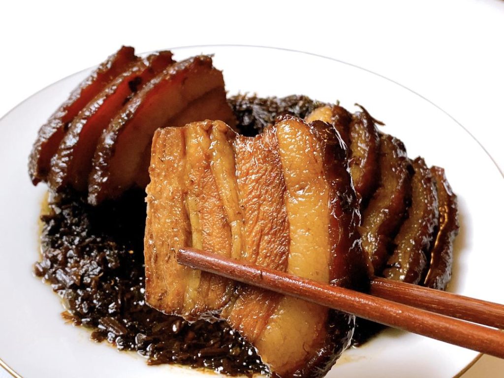 Remove the bowl from the steamer. Place a serving plate upside down over the bowl, and carefully flip them together. Lift the bowl off. If there is excess liquid, pour it into a saucepan, thicken it with a little cornstarch slurry, and pour it over the pork for a glossy finish.