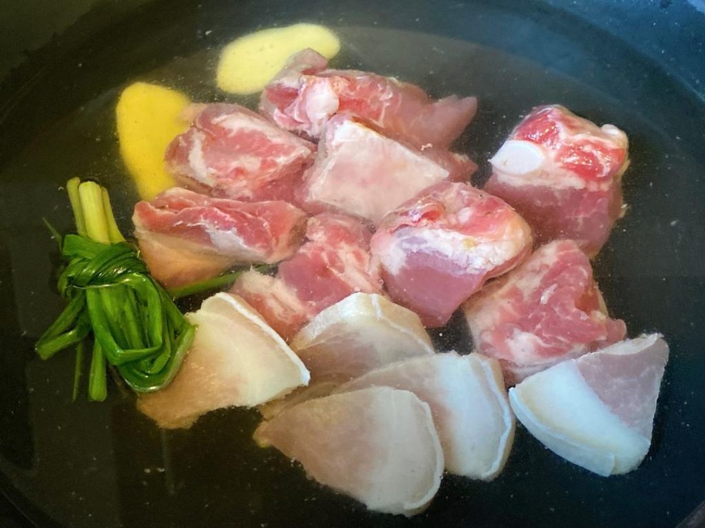 First Blanch (The Meat): Place the pork ribs and salted pork into a pot of cold water. Add 1 scallion knot, 2 slices of ginger, and 1 tbsp of Shaoxing wine. Bring to a boil over medium-high heat and blanch for 2 minutes. Remove the meat and rinse it clean with hot water.