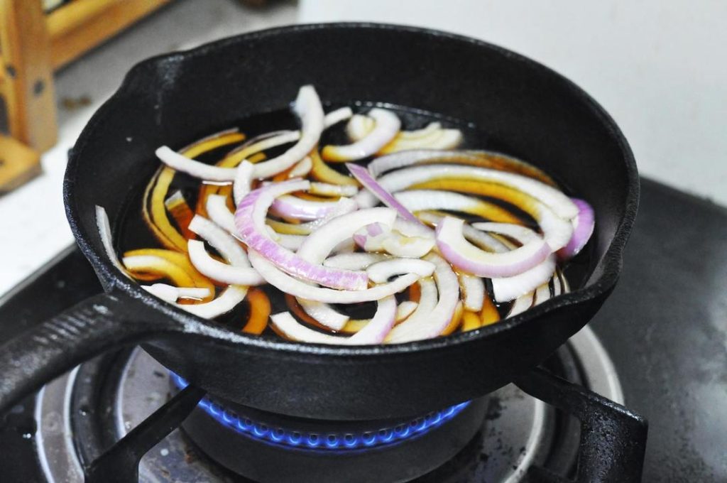 Simmer the Onions: Wipe the excess oil from the pan with a paper towel (leave a thin film for flavor if you like). Pour in the prepared sauce mixture and add the sliced onions. Bring to a boil over medium heat.