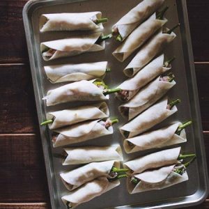Wrap the Dumplings Take a round dumpling wrapper. Moisten the edges with a little water. Wrap the dough around the middle section of the stuffed pepper (like a belt or a blanket). Press the seam tightly to seal. The tip and the stem of the pepper should still be visible.