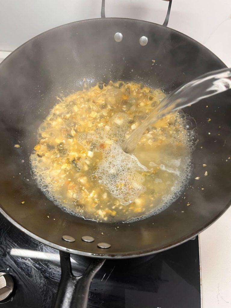Create the Broth: Turn the heat up to high. Pour in the boiling water. It should boil vigorously immediately.