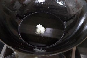 Melt the Lard Add the 3 tablespoons of lard to the hot scallion oil. Stir until fully melted and combined.