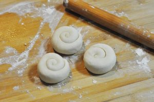 Press and Rest: Stand the "snail" on its end and flatten it with your palm to form a disc. This technique creates the flaky internal layers. Let these discs rest for another 10 minutes.