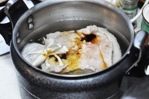 Combine Ingredients: Place the soaked pork belly chunks into your pressure cooker. Add the spice bag, salt, Dark Soy Sauce, Light Soy Sauce, and rock sugar.
