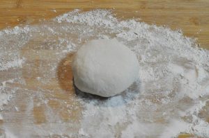 Make the Dough: In a mixing bowl, combine the flour, yeast, baking powder, and salt. Pour in the warm water. Mix until a shaggy dough forms, then knead for about 8-10 minutes until smooth.
