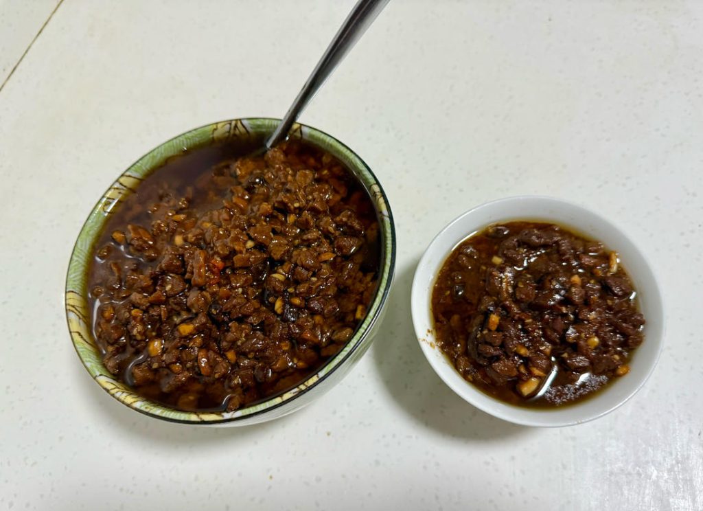 Let the sauce cool completely in the pot before transferring it to sterilized glass jars. The oil should cover the meat—this acts as a seal.