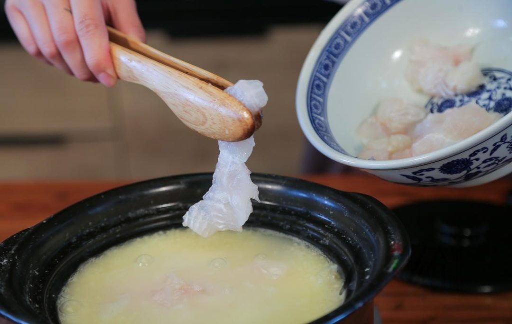 Add the Fish Once the millet is fully cooked and the porridge is creamy, turn the heat down to low.