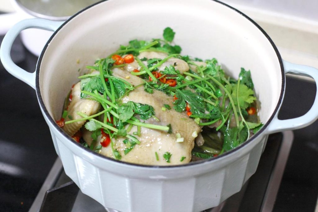 Pile the fresh cilantro leaves, chopped scallion greens, and chili rings on top of the chicken.