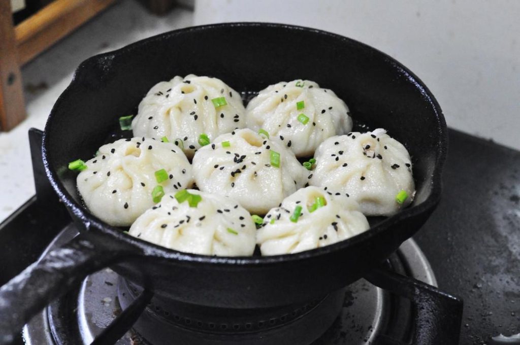Finish: Once the water evaporates, sprinkle with chopped scallions and sesame seeds. Turn off the heat and let it sit covered for another 2 minutes (this prevents the buns from collapsing).