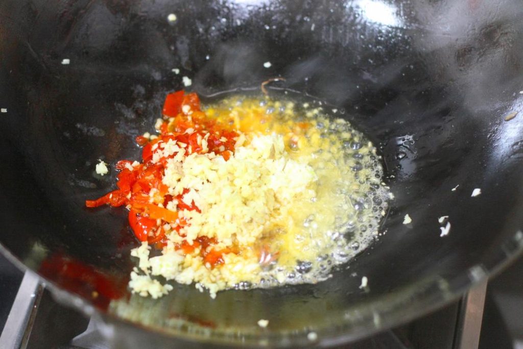 Create the Soup Base Add oil to the wok over medium heat. Add the minced pickled chilies, ginger, and the 2/3 portion of minced garlic. Stir-fry until fragrant. Add the tablespoon of Doubanjiang and stir-fry until the oil turns red (this releases the pigment and flavor). Pour in water (about 2-3 cups, enough to submerge meat). Season with 2 tsp light soy sauce, sugar, white pepper, and chicken essence. Bring to a boil. Add a little cornstarch slurry to slightly thicken the broth.