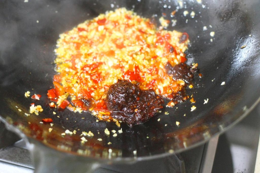 Create the Soup Base Add oil to the wok over medium heat. Add the minced pickled chilies, ginger, and the 2/3 portion of minced garlic. Stir-fry until fragrant. Add the tablespoon of Doubanjiang and stir-fry until the oil turns red (this releases the pigment and flavor). Pour in water (about 2-3 cups, enough to submerge meat). Season with 2 tsp light soy sauce, sugar, white pepper, and chicken essence. Bring to a boil. Add a little cornstarch slurry to slightly thicken the broth.