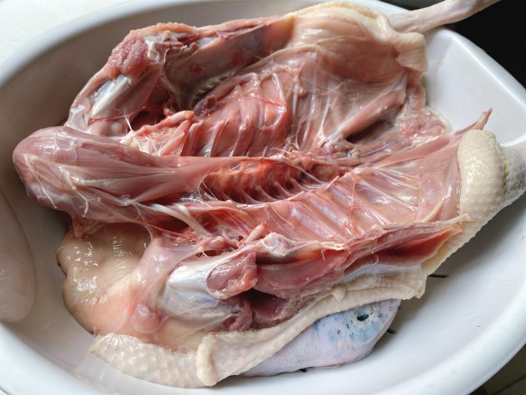 Clean the Duck: Remove any remaining pinfeathers, inner organs, and the tail. Rub the entire duck thoroughly with a handful of plain salt to clean the skin. Rinse thoroughly under cold running water to wash away blood and impurities. Pat the duck completely dry inside and out.