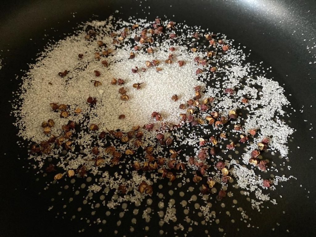 Toast the Rub: Heat a dry skillet over low heat. Add 3 grams of Sichuan peppercorns and 15 grams of salt. Toast gently for 3–5 minutes, stirring constantly. You will know it is done when the salt takes on a slightly yellowish hue and the peppercorns release a strong, fragrant aroma. Remove from heat and let cool.