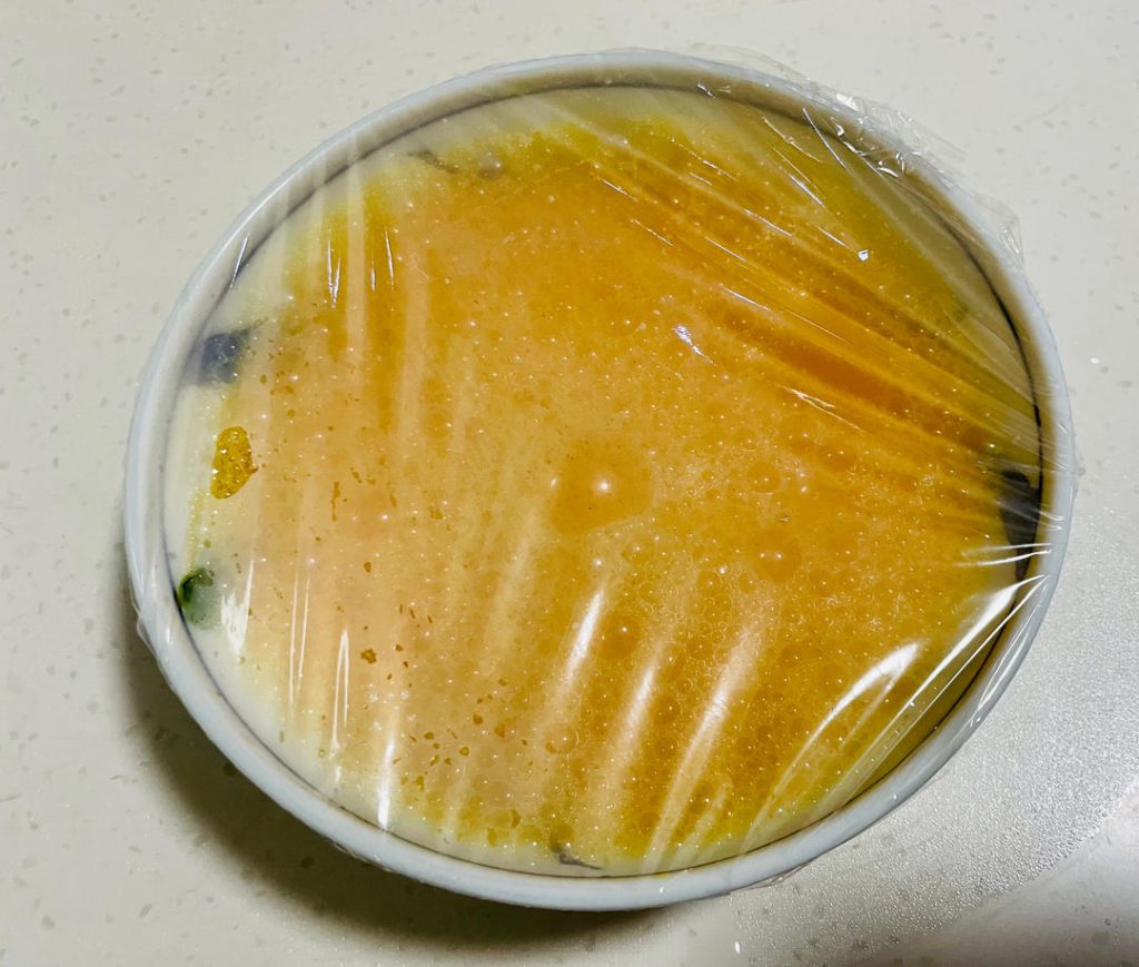 Seal the Bowl: Take your bowl of beaten egg and water, and cover it tightly with heat-safe plastic wrap. Using a toothpick, poke 4 to 5 small holes in the plastic wrap. This allows steam to vent gently while protecting the surface from water droplets.