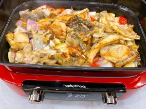 The "Dry" Braise Arrange the seared fish chunks neatly on top of the aromatic vegetable bed.