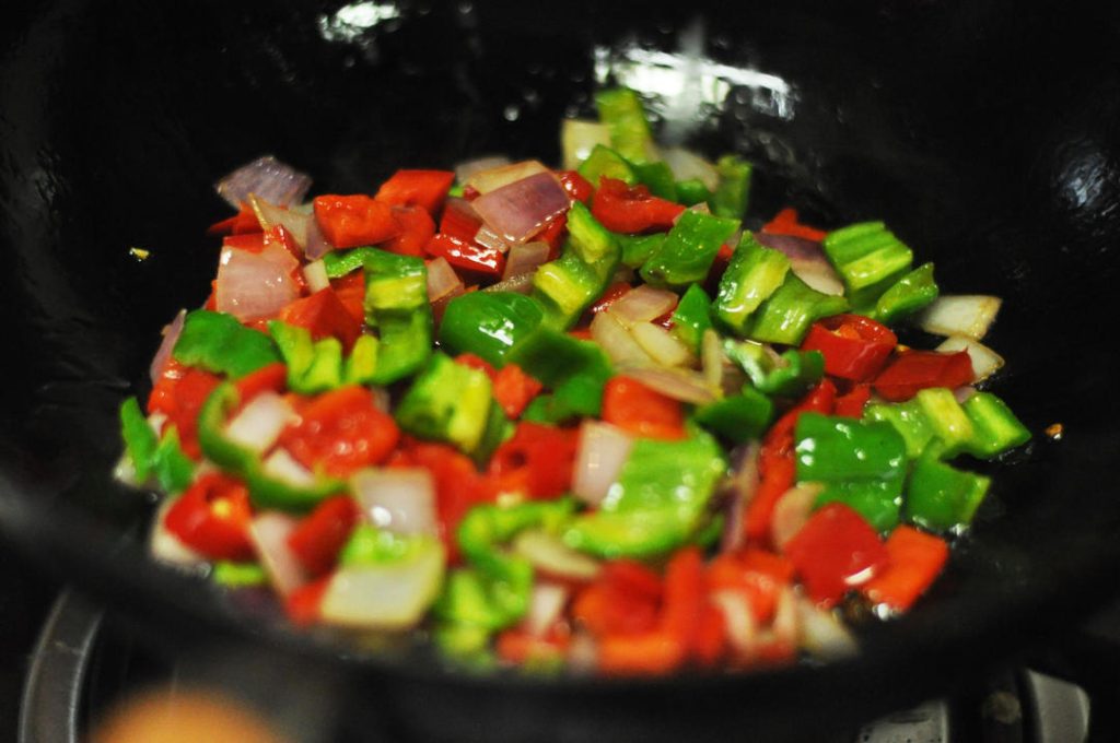 Cook the Peppers Add the diced green and red peppers to the pan. Stir-fry for about 1 minute. You want them to soften slightly but still retain some crunch ("crisp-tender").